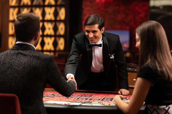 TTTJILI — A high-class gaming experience without limits A woman in a luxurious green gown next to an ornate roulette wheel, capturing the upscale casino mood of TTTJILI.